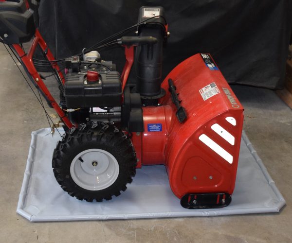 Red snowblower on grey antiskid mat